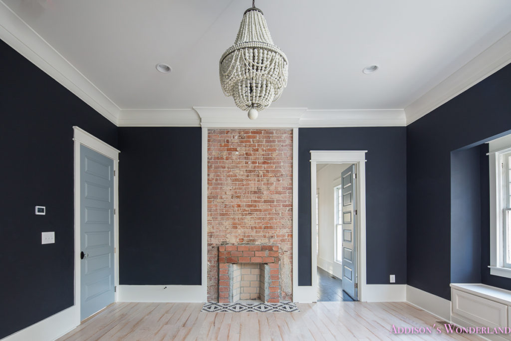 master-bedroom-black-walls-malibu-chandelier-brick-fireplace-inkwell-bluedoors-shaw-whitewashed-hardwood-floors