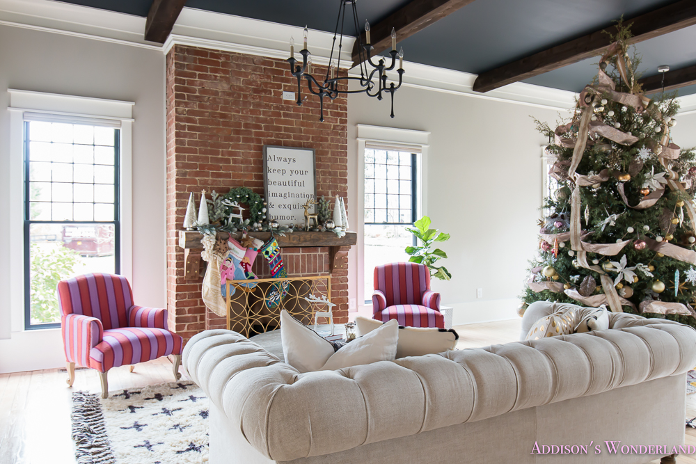 vintage-living-room-black-ceiling-brick-fireplace-dark-wood-beams-anthropologie-home-tufted-sofa-christmas-1-of-23