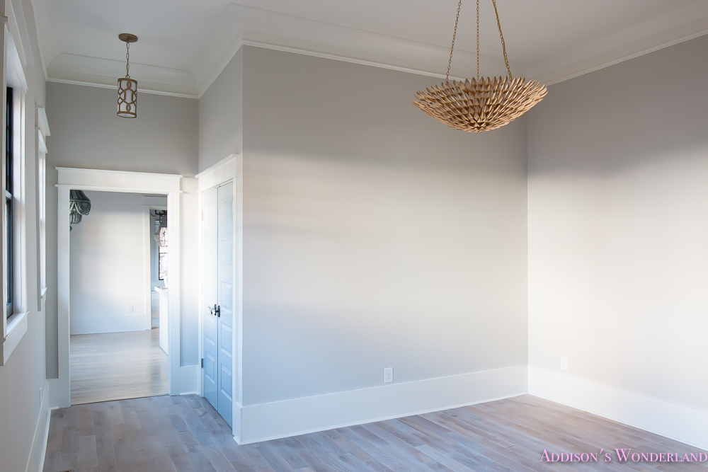 living-room-light-gray-walls-grey-gold-chandelier-black-window-sashes-whitewashed-hardwood-flooring-light-blue-doors-4-of-6